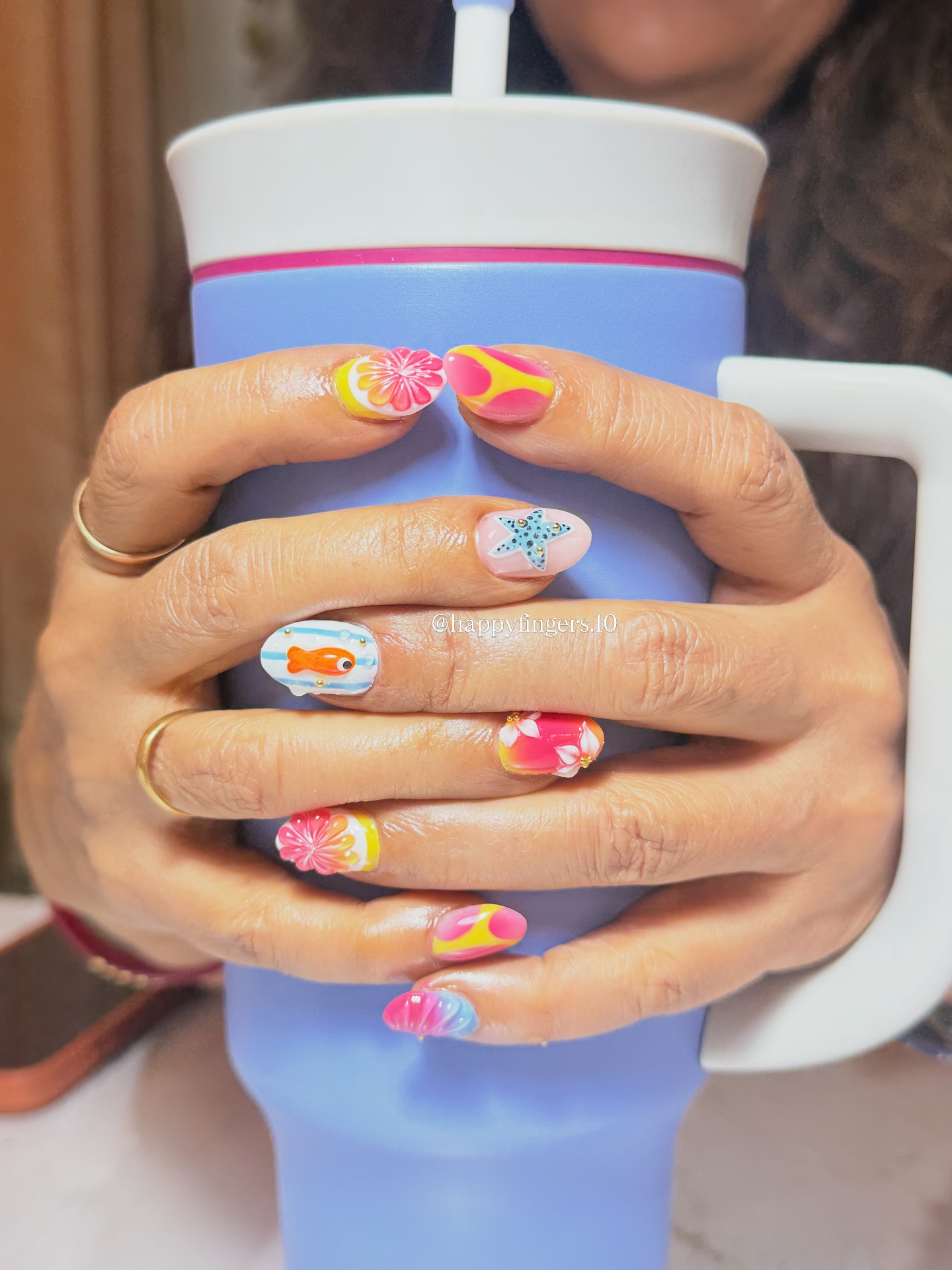 Summer nails styled on a frosted tumbler
