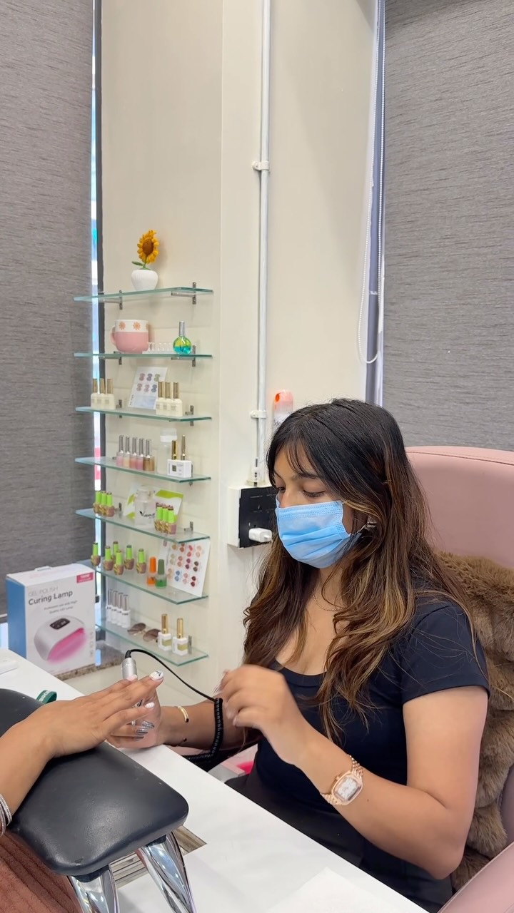 Priya Vora hand-painting a client's nails at the Happy Fingers studio